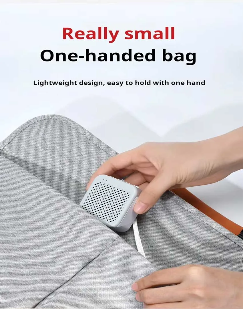 Hand holding the sleek Vositone M1 Mini Wireless Speaker